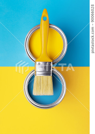 Can of yellow paint on yellow and blue background. 90066028