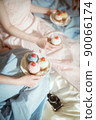 Women having a girls talk while holding a cake 90066174