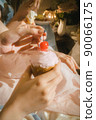 Hands of a woman holding a cake 90066175