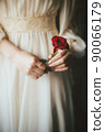 Woman in a dress with a red rose 90066179