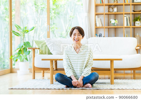 Middle woman relaxing in the living room Middle woman relaxing in the living room 90066680