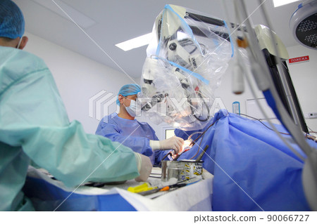 Treatment of a brain aneurysm. Surgical operation on the brain. A team of surgeons performing brain surgery to remove a tumor. Treatment of a brain aneurysm. Surgical operation on the brain. A team of surgeons performing brain surgery to remove a tumor. 90066727