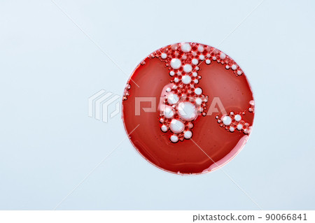 Abstract petri dish with cosmetic or medical liquid on blue background top view. Science cosmetic laboratory concept. 90066841