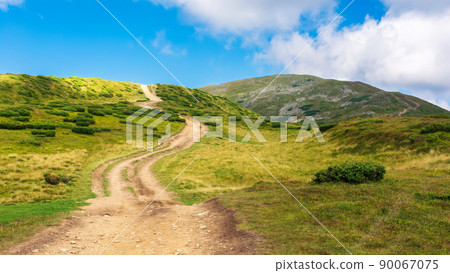 trail uphill the petros peak. beautiful summer landscape of carpathian mountains. success and achievement concept. grassy hill beneath a sky with clouds trail uphill the petros peak. beautiful summer landscape of carpathian mountains. success and achievement concept. grassy hill beneath a sky with clouds 90067075