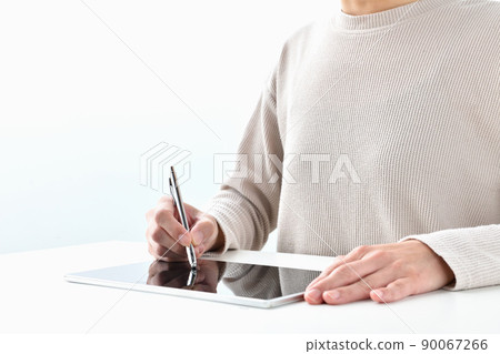 A woman's hand to sign on a tablet A woman's hand to sign on a tablet 90067266