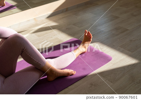 Top views attractive young woman working out at home, doing yoga exercise on blue mat, sitting in Easy Decent 90067601