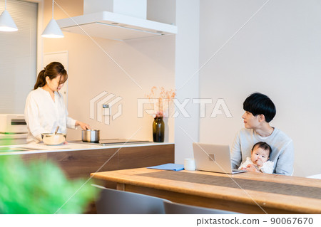 Daddy using a computer with a baby 90067670
