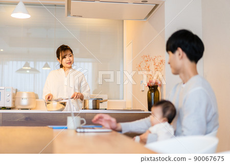 Daddy using a computer with a baby 90067675