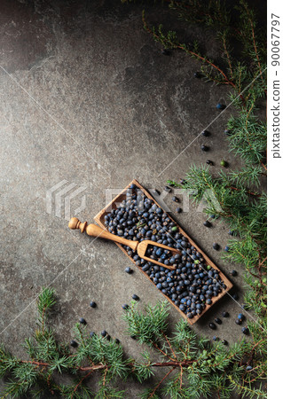Wooden bowl with seeds of juniper. 90067797