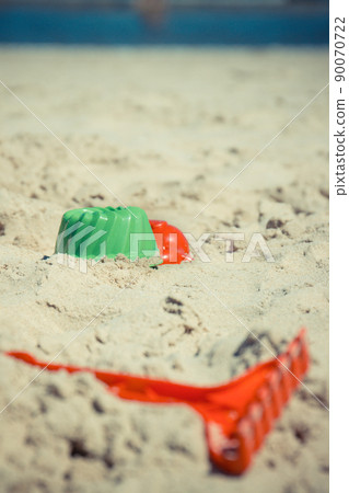 Plastic green rake and other toys using for relax or playing at beach 90070722