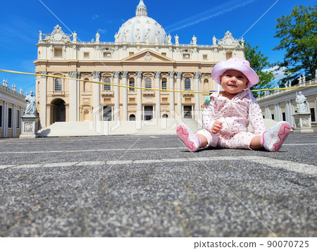 Baby girl sitting on a european city street. Little child outdoors in a town. Baby girl sitting on a european city street. Little child outdoors in a town. 90070725