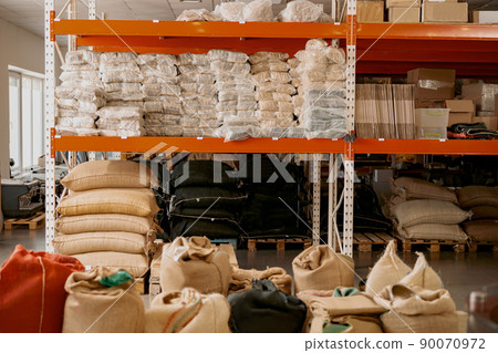 Warehouse of a small coffee factory with shelves and bags 90070972