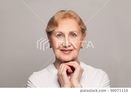 Happy woman face. Portrait of beautiful mature woman smiling while looking and camera 90071118