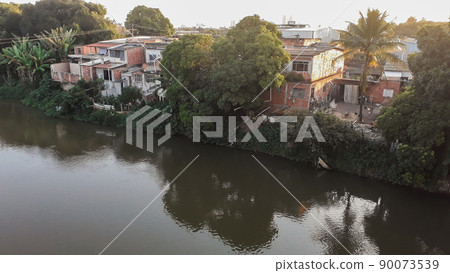 Mighty Paraiba do Sul river in Volta Redonda, Rio de Janeiro, Brazil. houses on the banks of the polluted river 90073539