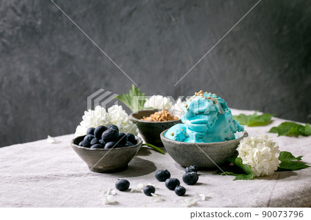 Turquoise ice cream in waffle cones 90073796