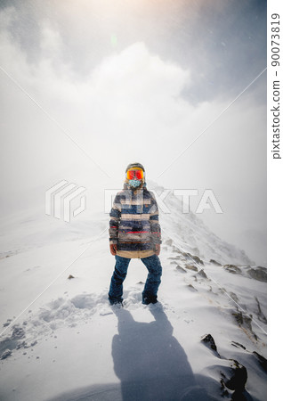 Portrait of a pretty and active woman skier, wearing a mask, active winter holidays Portrait of a pretty and active woman skier, wearing a mask, active winter holidays 90073819