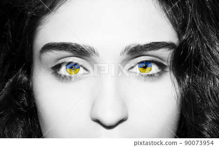 Flag of Ukraine in beautiful woman eyes. 90073954