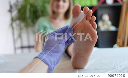 Doctor holds brace for hallux valgus closeup Doctor holds brace for hallux valgus closeup 90074018