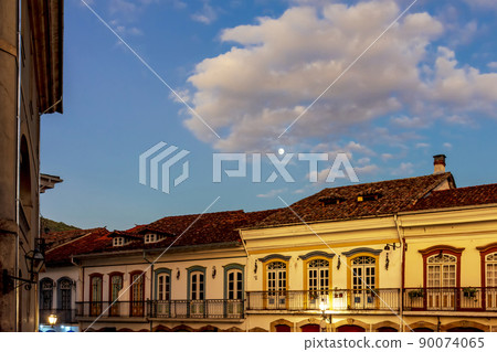 Facades of old colonial style houses with their balconies and windows 90074065