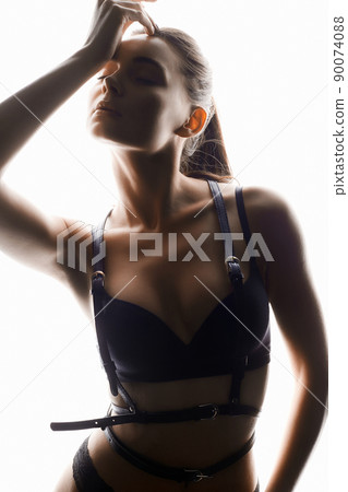 Beautiful woman in leather accessories and underwear. sexy girl in white lights Beautiful woman in leather accessories and underwear. sexy girl in white lights 90074088