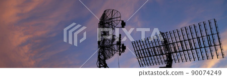 Air defense radars of military mobile anti aircraft systems, modern army industry on the background of the sunset orange sky, Russia 90074249