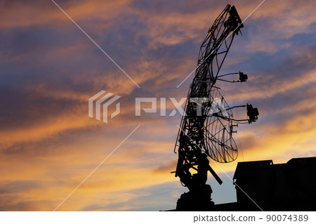 Air defense radars of military mobile anti aircraft systems, modern army industry on the background of the sunset orange sky, Russia 90074389