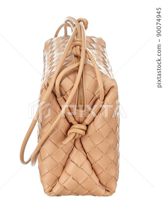 Gorgeous little handbag made of woven beige leather, isolated on a white background. Side view. Expensive women's accessories. Gorgeous little handbag made of woven beige leather, isolated on a white background. Side view. Expensive women's accessories. 90074945