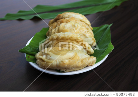 Malaysia popular and traditional snack Karipap filled with potato fillings. 90075498