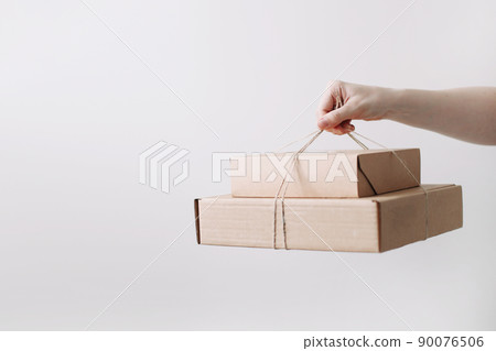 hands holding cardboard boxes. Online shopping and express delivery concept. 90076506