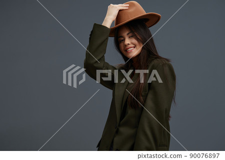 young woman in a suit with a hat posing casual wear isolated background young woman in a suit with a hat posing casual wear isolated background 90076897