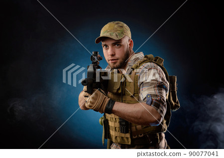 guy's a military agent in a bulletproof vest with an automatic rifle guy's a military agent in a bulletproof vest with an automatic rifle 90077041