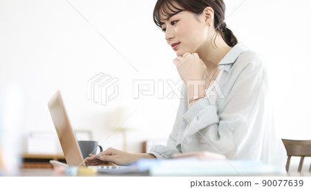 Young woman working remotely Young woman working remotely 90077639