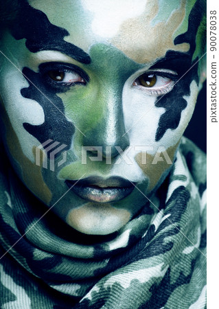 Beautiful young fashion woman with military style clothing and face paint make-up, khaki colors, halloween celebration closeup Beautiful young fashion woman with military style clothing and face paint make-up, khaki colors, halloween celebration closeup 90078038
