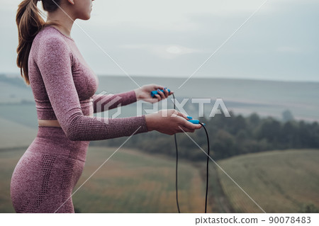 Side View of Unrecognisable Young Woman Holding Skipping Rope, Girl Working Out Outdoors on the Hill 90078483