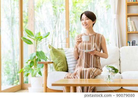 Middle woman relaxing in the living room Middle woman relaxing in the living room 90079080