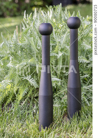 pair of heavy steel clubs in backyard pair of heavy steel clubs in backyard 90080715