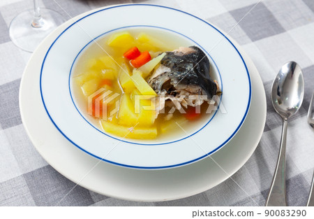 Plate of salmon head fish stock with potatoes and carrot Plate of salmon head fish stock with potatoes and carrot 90083290