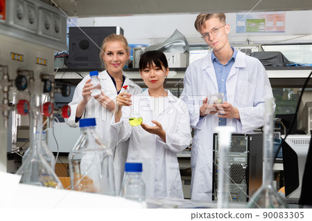 Group of European and Chinese scientists posing together at biochemical laboratory 90083305