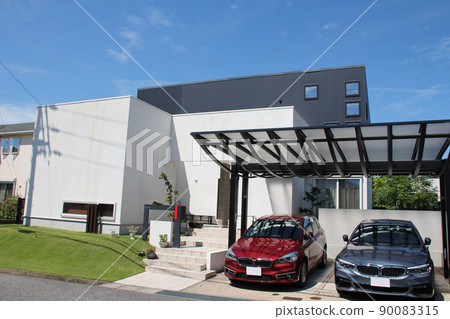 A modern, lovely and beautiful mansion with stylish white and black box-shaped windows that shine in the blue sky 90083315