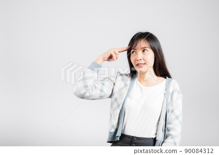 Depressed woman wanting shooting to kill herself by holding fingers on her head 90084312