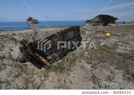 Abandoned ship buried in a sandy beach Abandoned ship buried in a sandy beach 90086510