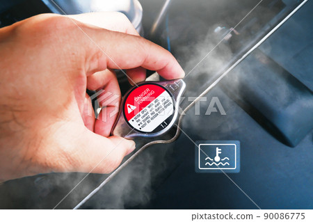 The mechanic hand was holding onto the car hot radiator cap with the water smoke The mechanic hand was holding onto the car hot radiator cap with the water smoke 90086775