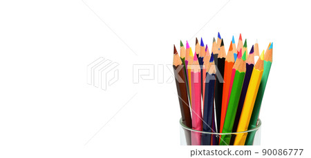 Several colored pencils in a crayon glass holder isolated with copy space on white background 90086777