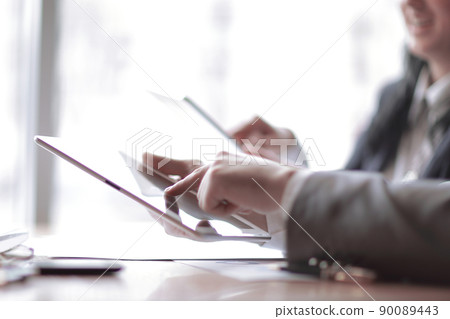 businessman clicks on the screen of a digital tablet 90089443
