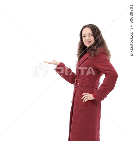 smiling young woman in red coat showing on copy space 90089901