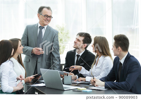 senior businessman discussing with business team to work issues senior businessman discussing with business team to work issues 90089903
