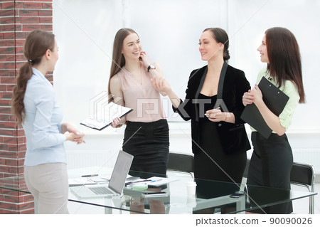business woman and her team standing in a modern office business woman and her team standing in a modern office 90090026