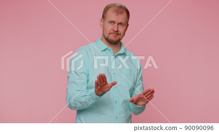 Man warning with admonishing finger gesture, saying no, be careful, avoid danger, disapproval sign 90090096