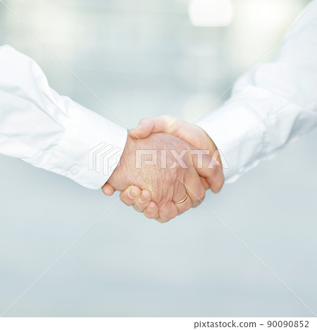closeup. handshake business people in blurred background. 90090852