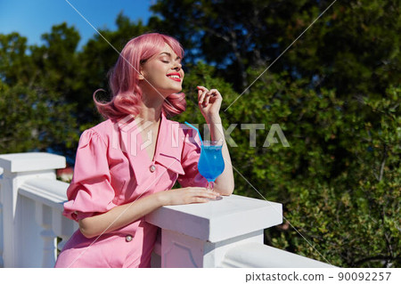 Delighted young girl with pink hair summer cocktail refreshing drink unaltered Delighted young girl with pink hair summer cocktail refreshing drink unaltered 90092257
